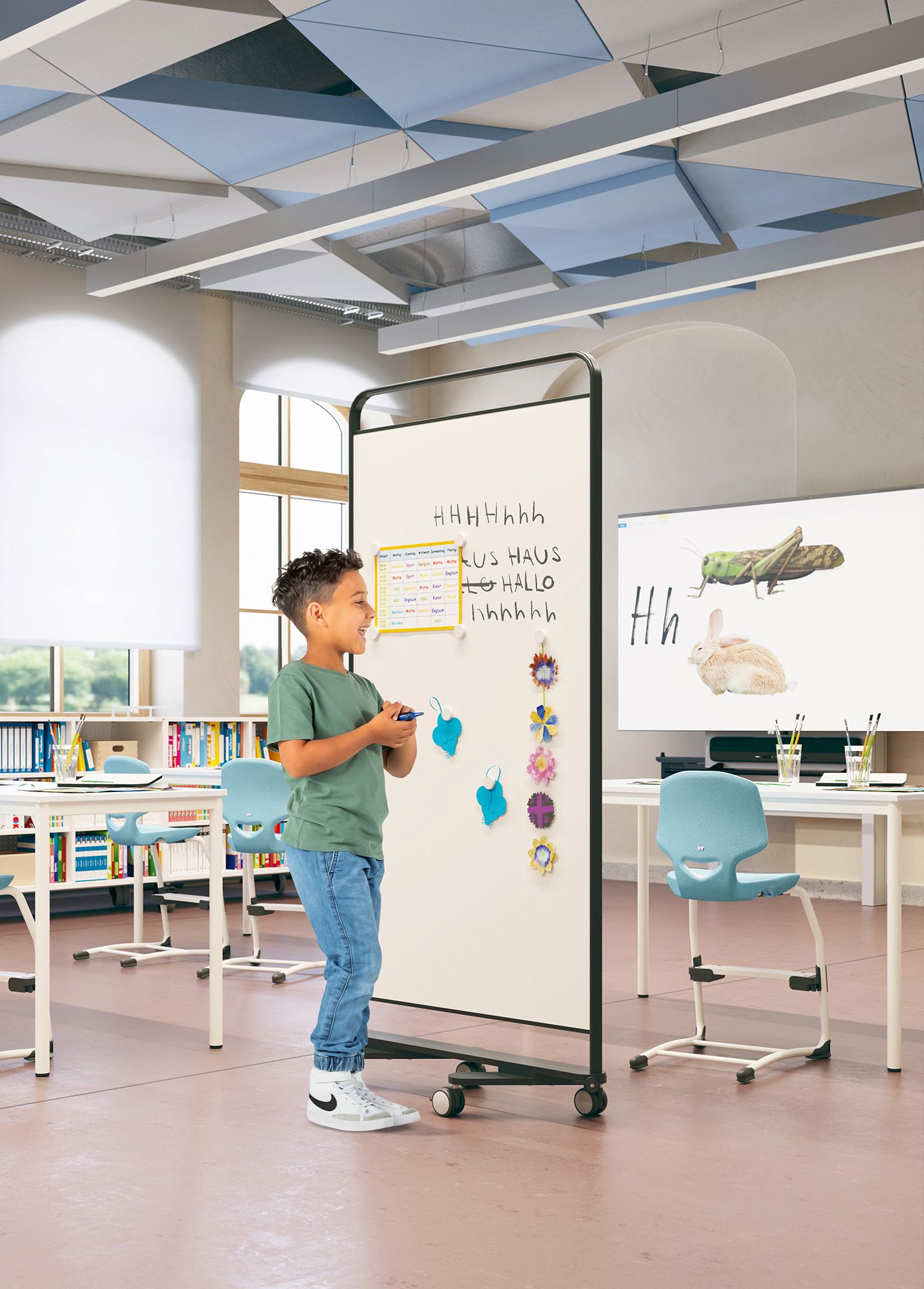 A boy writes on a mobile whiteboard in a classroom.