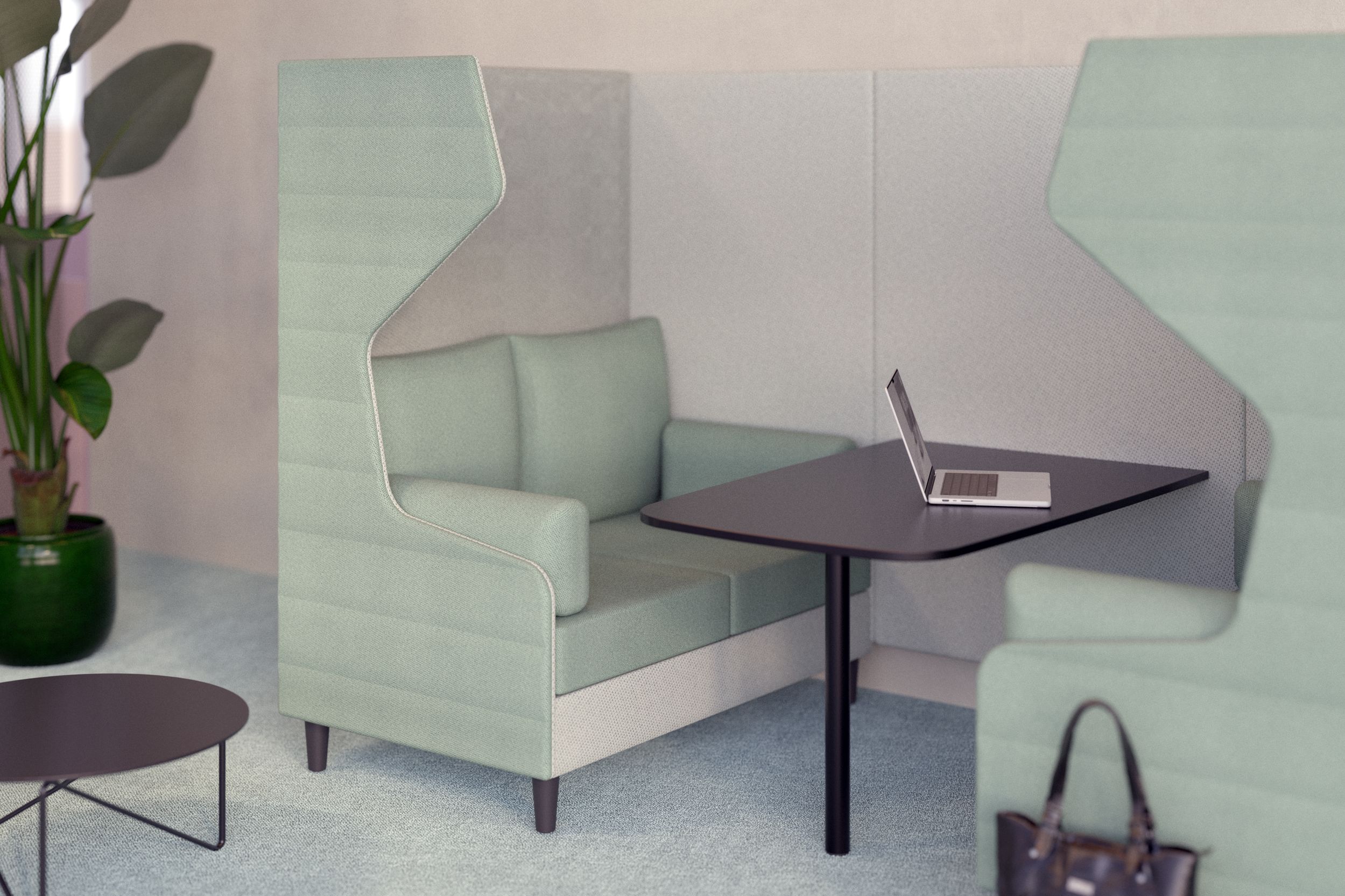 Hochlehner sofa in mint green in the studio, with a meeting table and a laptop