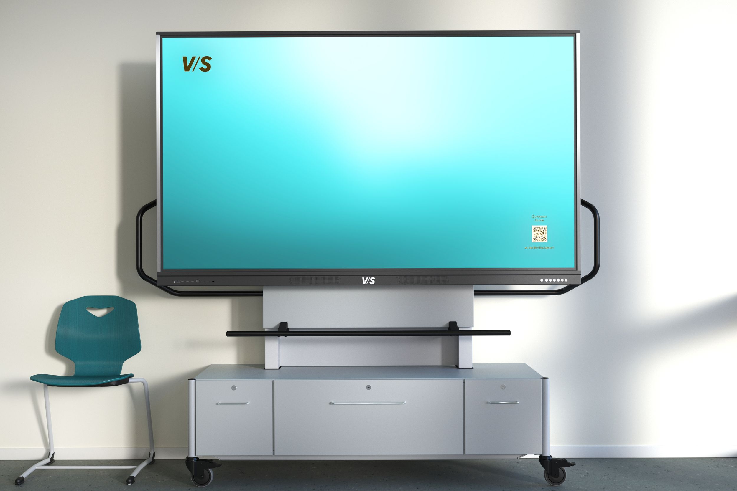 VS Display on VS MediaCenter GF 1.0 – a mobile, gas-spring height-adjustable mounting system with built-in storage, alongside a VS Jumper chair in teal.