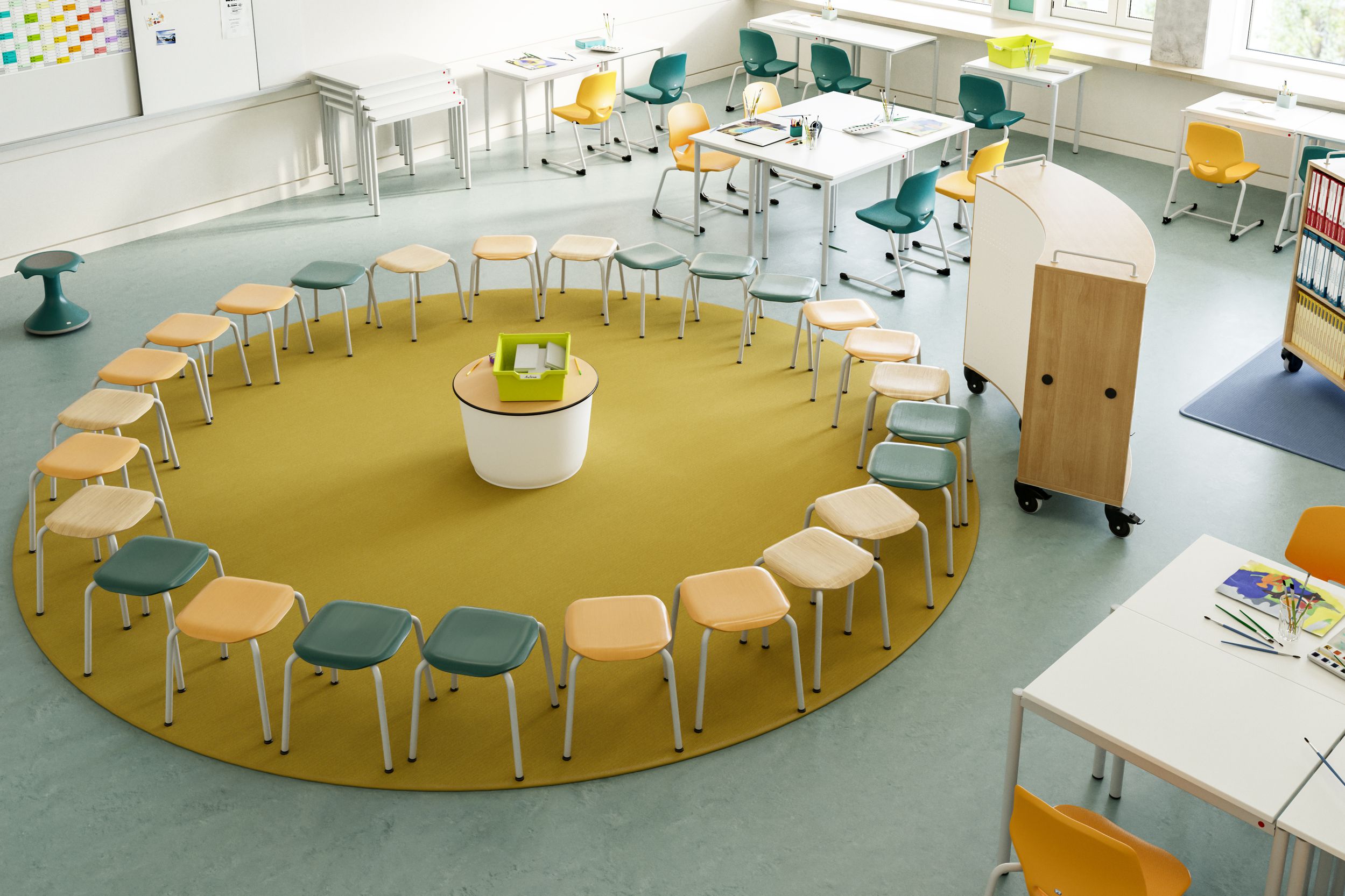 Flexible elementary school learning space featuring a circle of stools, stackable tables, cantilever chairs, and a mobile bookshelf from VS