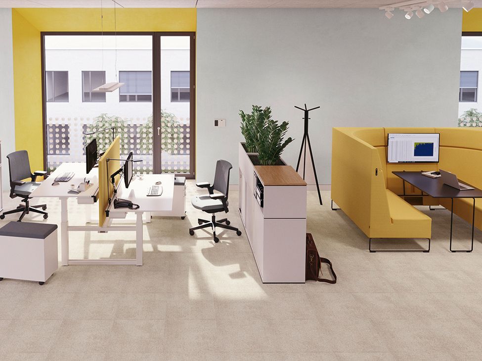 Open-plan office landscape with double workstations and meeting corner featuring HiBack armchairs from the Lounge series