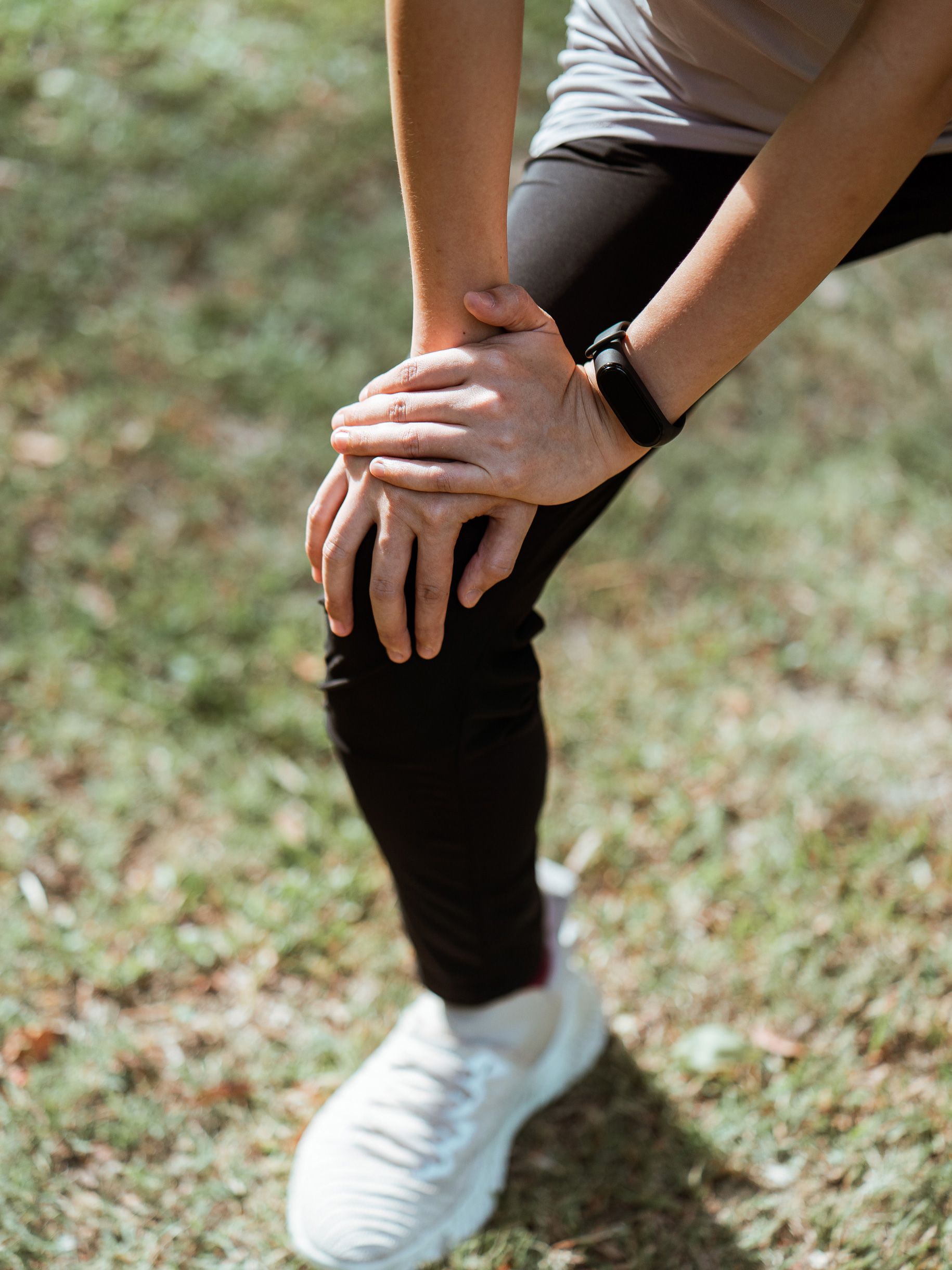 A person leaning on their knee during stretching exercises