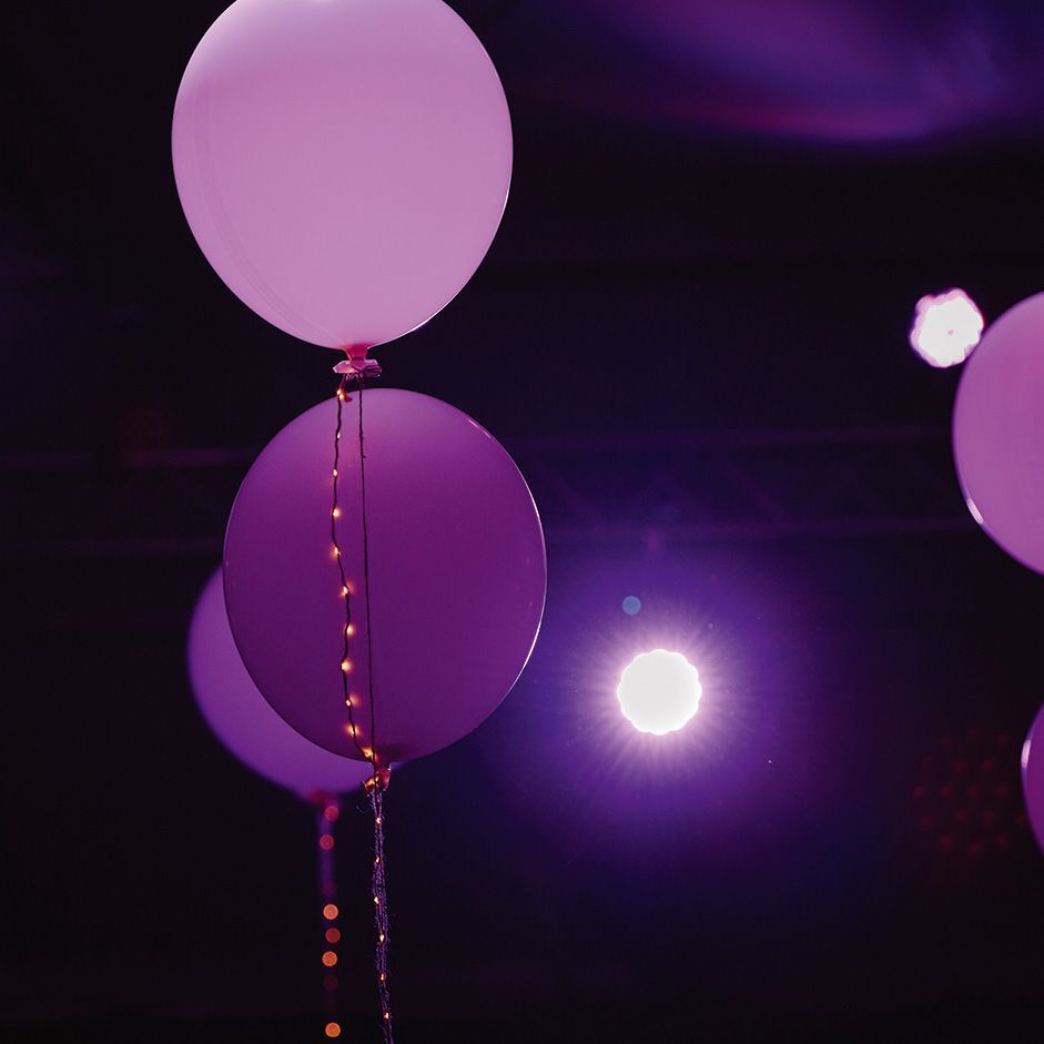 Purple balloons with chains of lights provide the right atmosphere at the 125th anniversary VS company party.