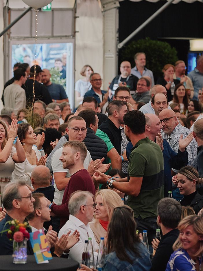 Guests at the 125th anniversary celebration of VS clap in sync with the music.