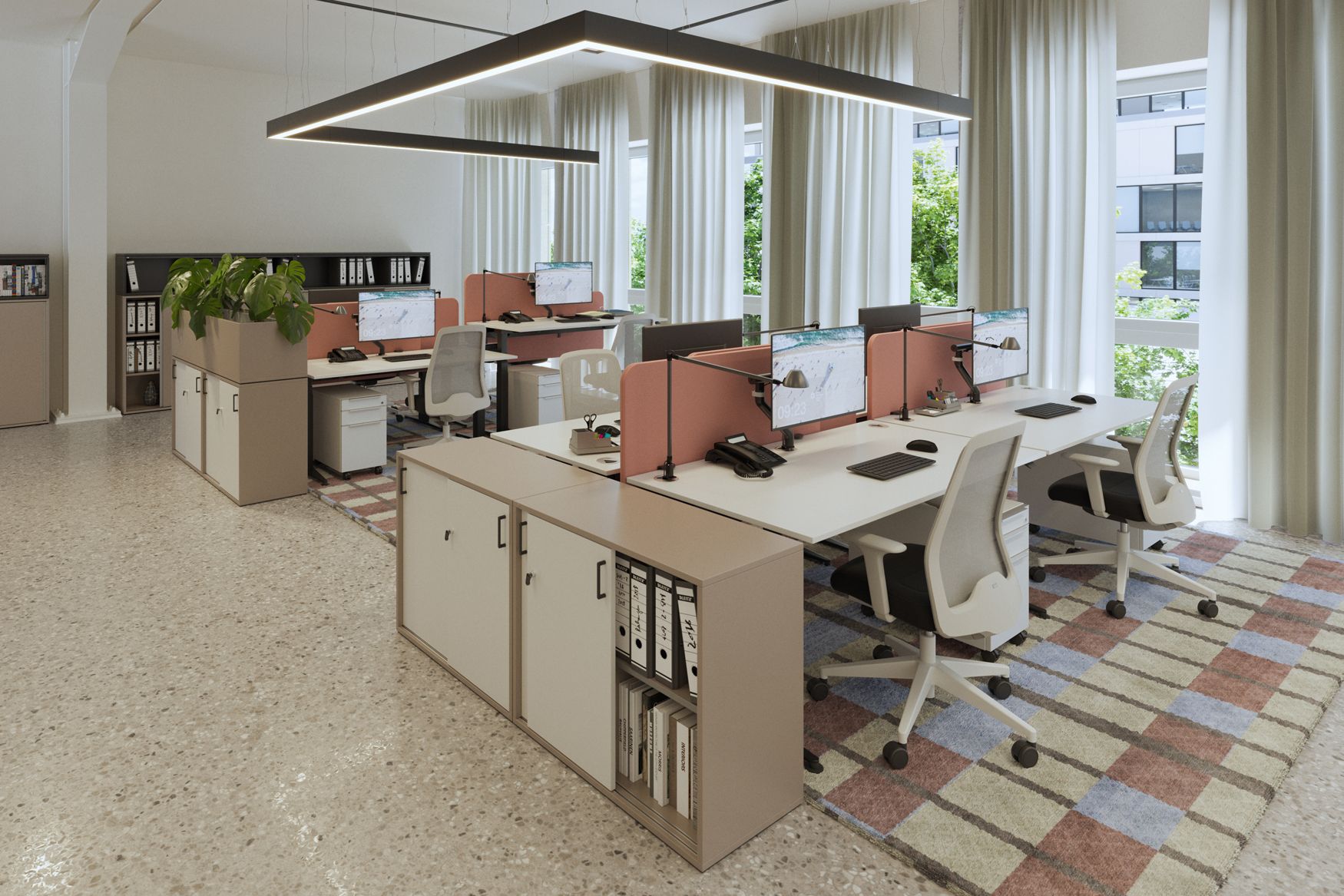 Open workspace with S902 desks, office chairs, monitors, and pink privacy panels; storage space separates the workstations.