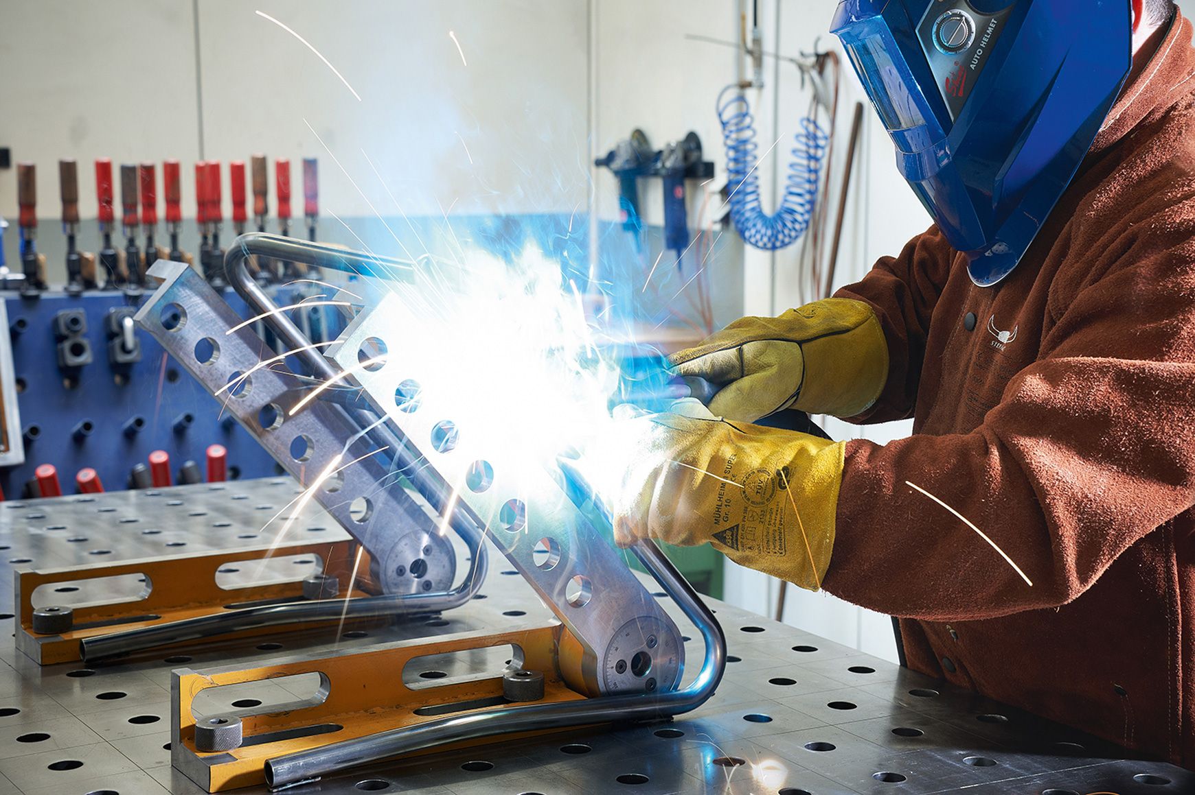 A person welds a frame for a prototype of a VS cantilever chair