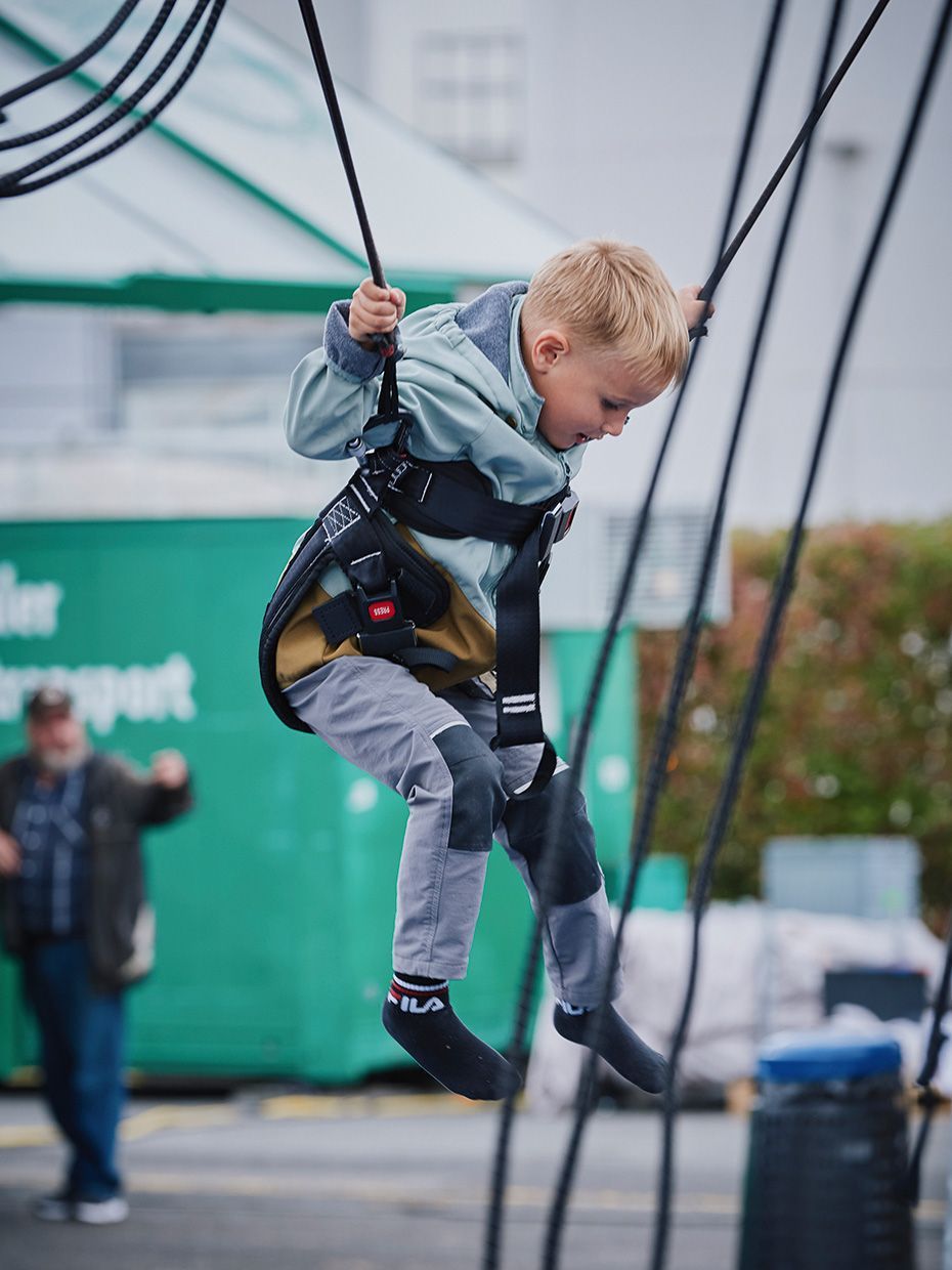 A child jumps on a bungee trampoline at the VS open day