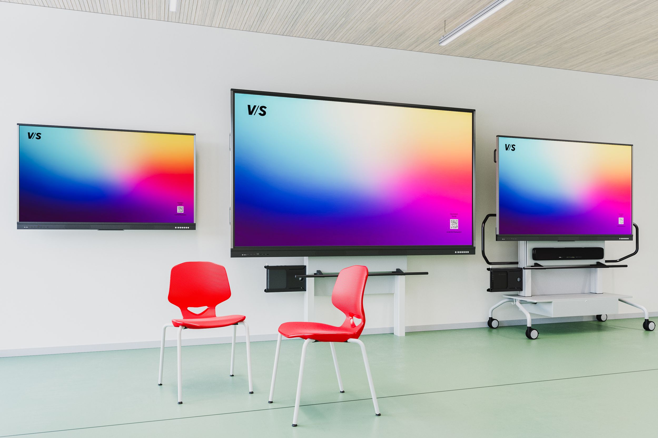Three VS DUAL displays in various sizes mounted on the wall, with two red VS Jumper Air Four chairs in front of them—the right display size for every learning environment.