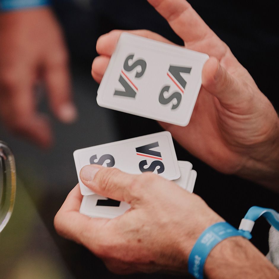A magician entertains the guests at the 125th anniversary celebration with card tricks.