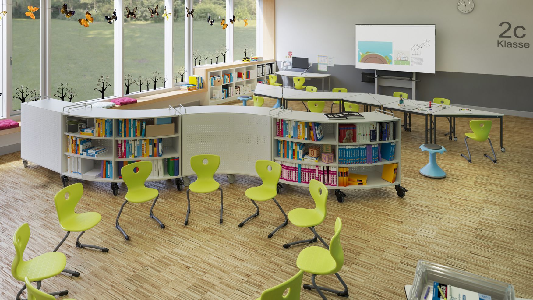 Flexible learning studio in an elementary school featuring TriTables, mobile shelving units, student chairs, and activity stools from VS