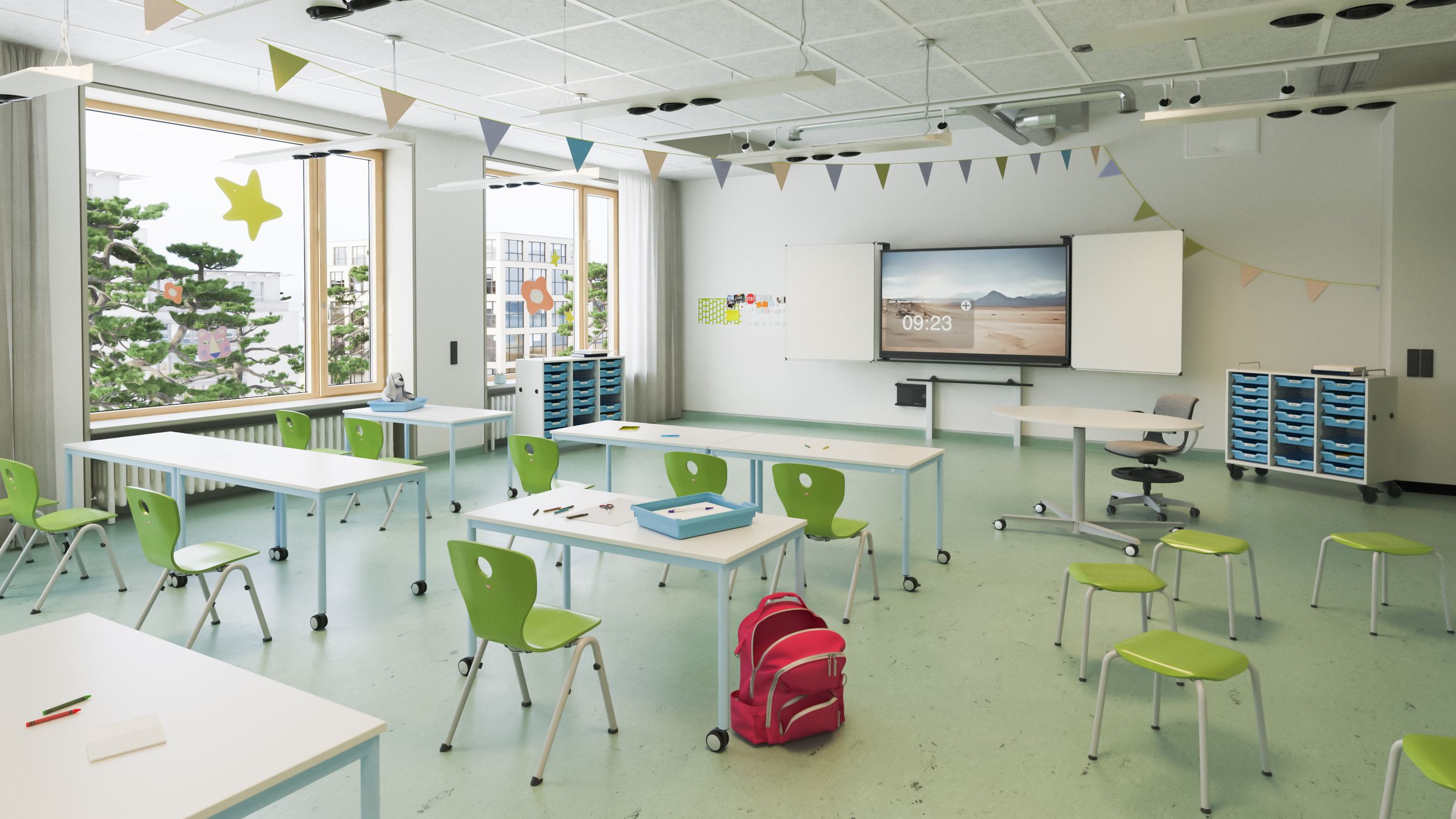 A bright elementary school classroom featuring VS Compass-Lupo chairs in green, mobile desks, a whiteboard, and a VS DUAL display on the wall.