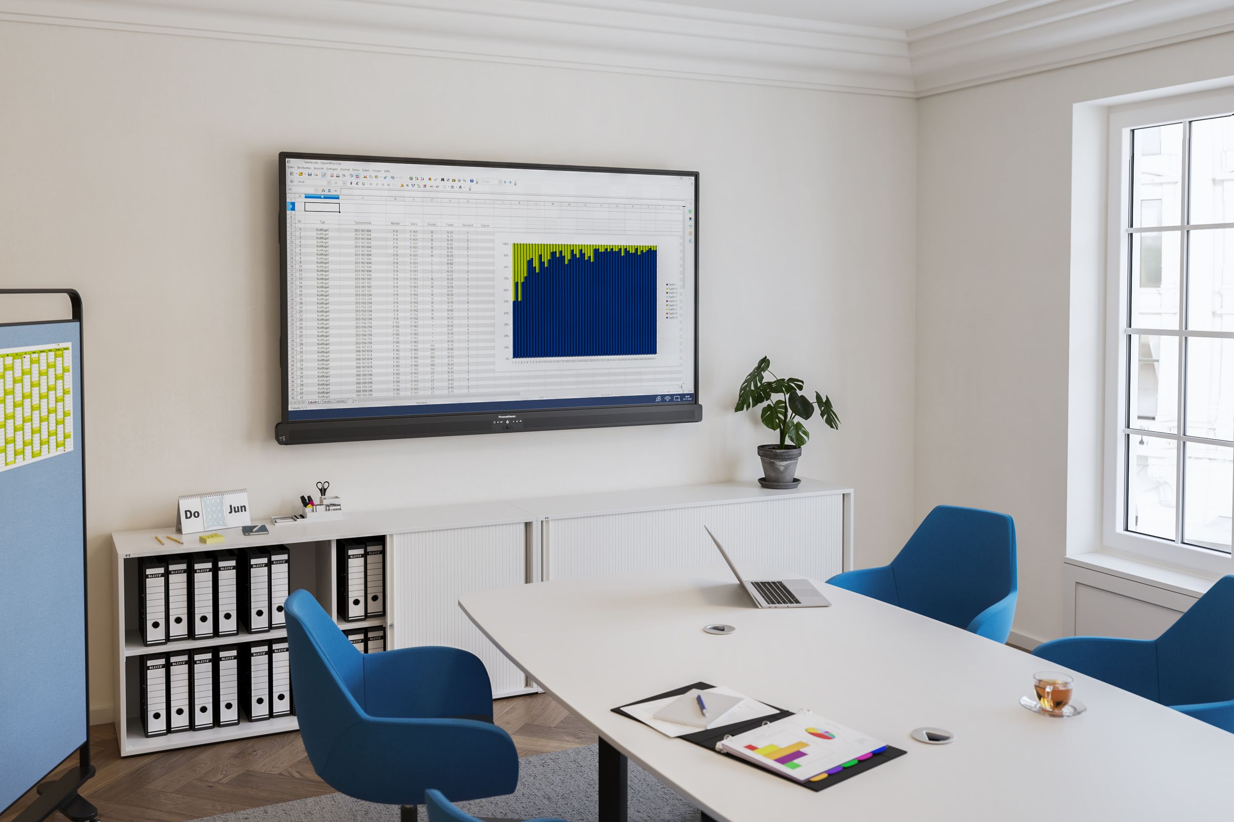 Modern office with a wall-mounted Promethean ActivPanel 10 LinkUp – displaying an Excel spreadsheet with a chart. In front of it, VS Fan chairs in blue are arranged around a conference table