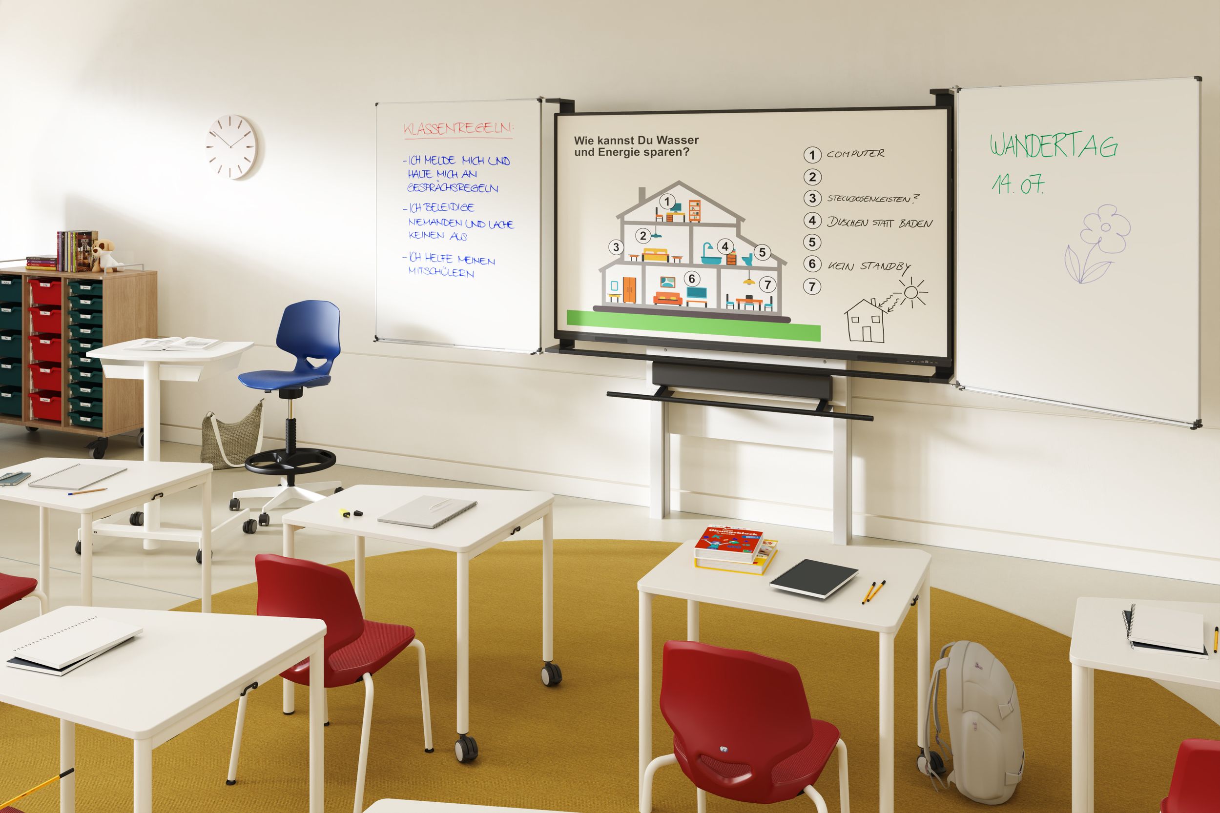 Elementary school classroom featuring VS Tano desks, VS Jumper Four chairs in red, and a VS Jumper Ply teacher’s swivel chair in blue—with a VS-S-C3 display on the wall flanked by whiteboards.