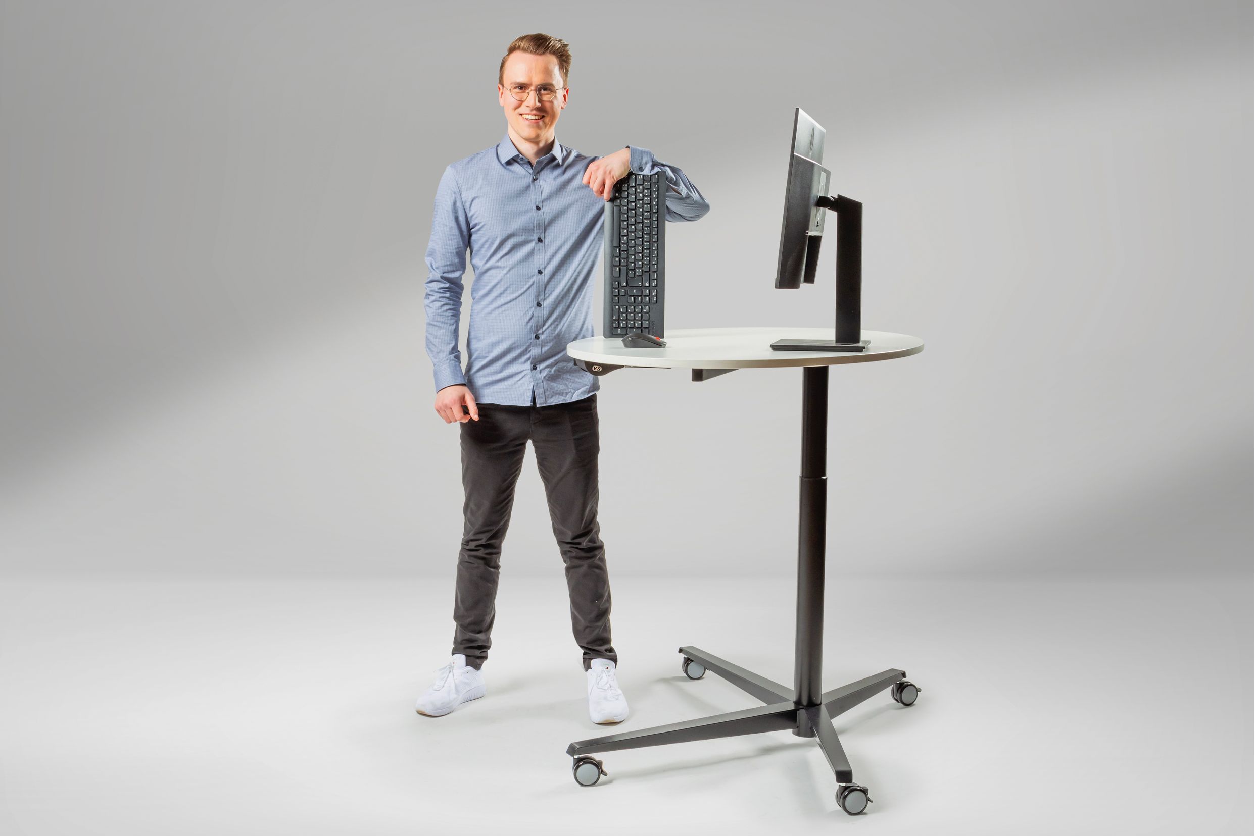 Junger Auszubildender für Fachinformatik lacht in die Kamera mit PC-Hardware