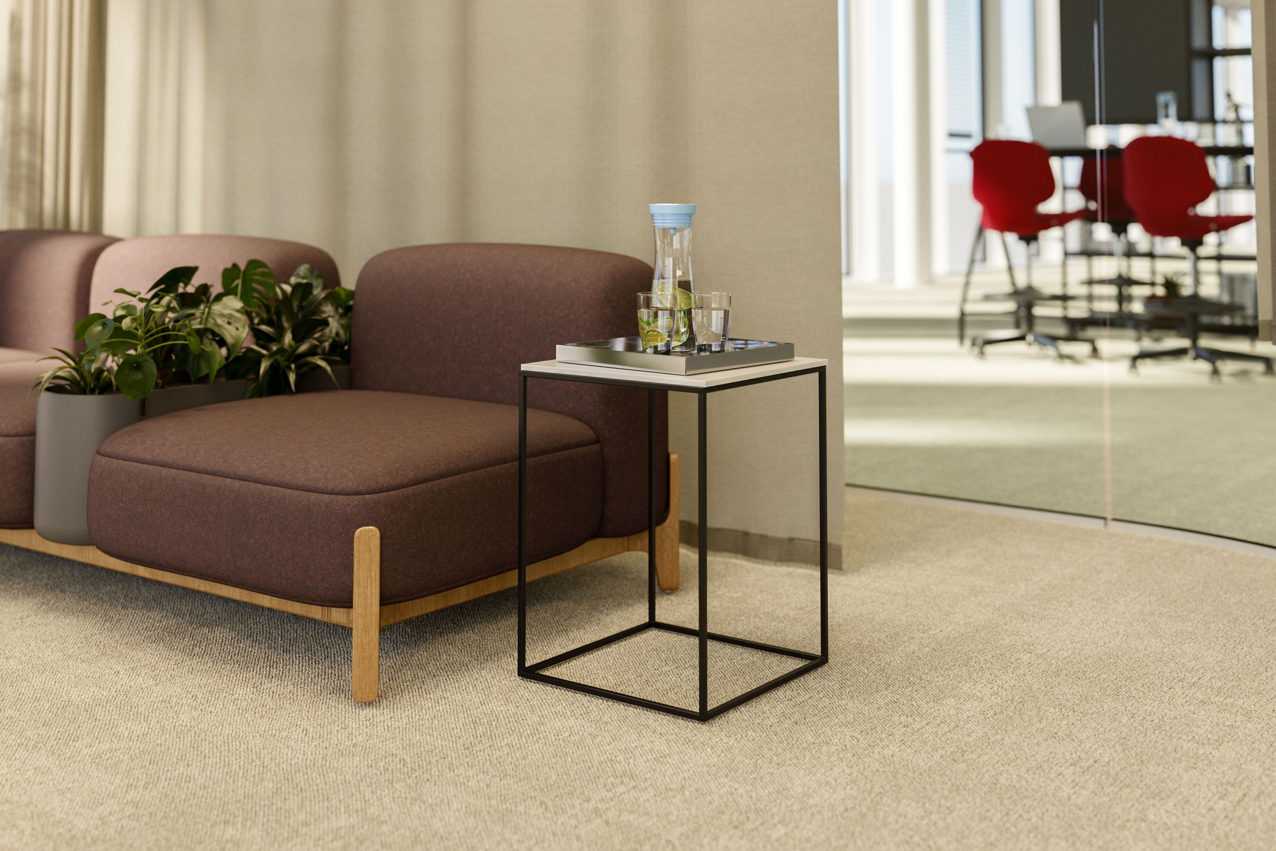 Frameless side table with a tray next to a lounge sofa featuring integrated plants